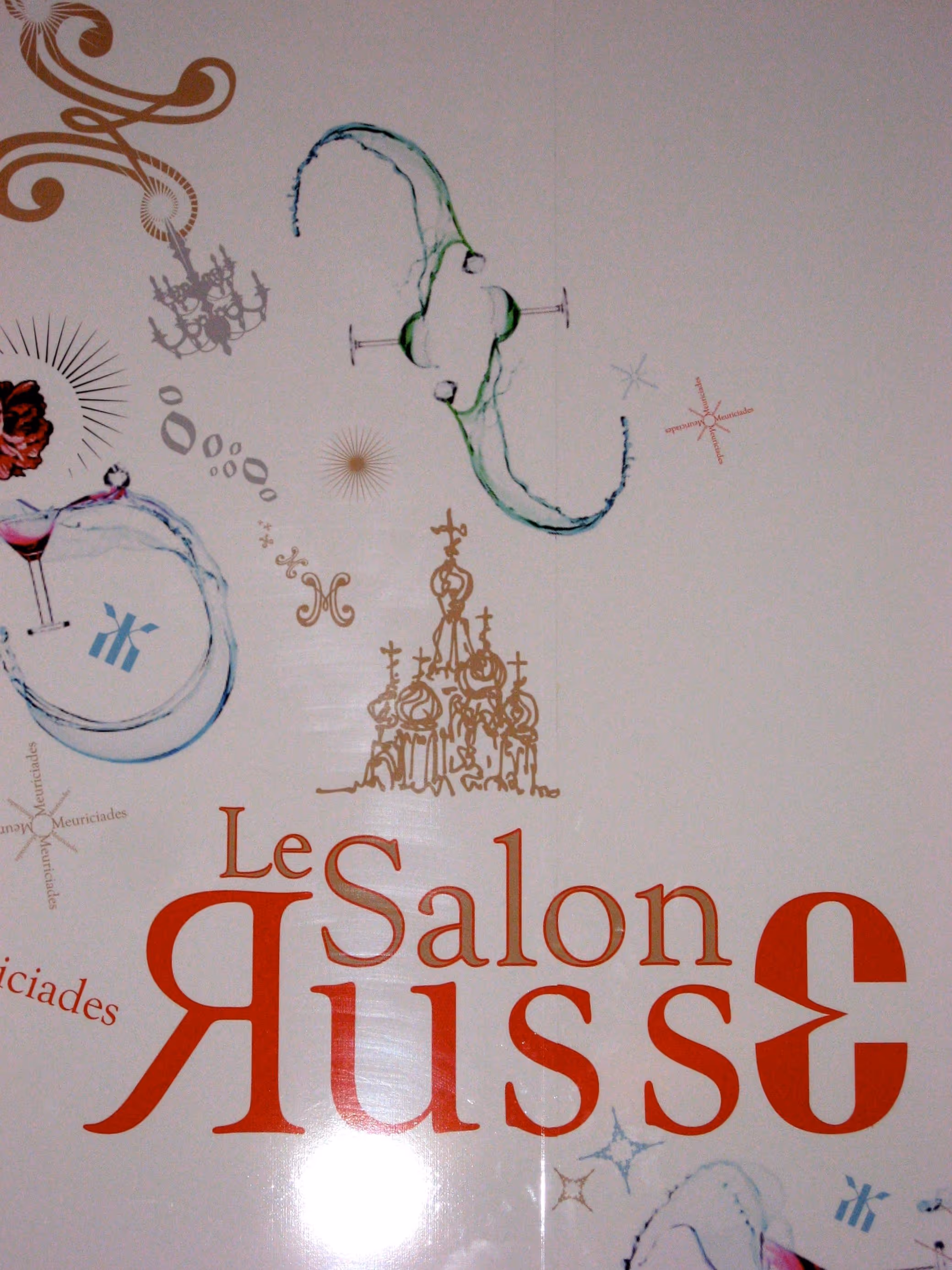Wall art with the text 'Le Salon Russe' featuring decorative motifs including a chandelier, cocktail glasses, and an architectural sketch.