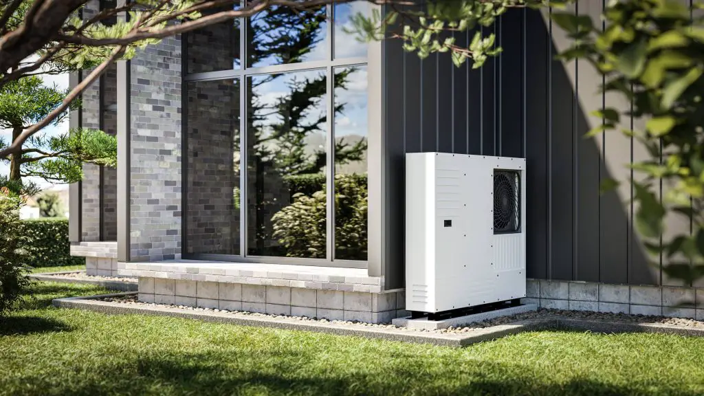 Modern house exterior with large windows and a white outdoor HVAC or heat pump unit on a concrete platform.