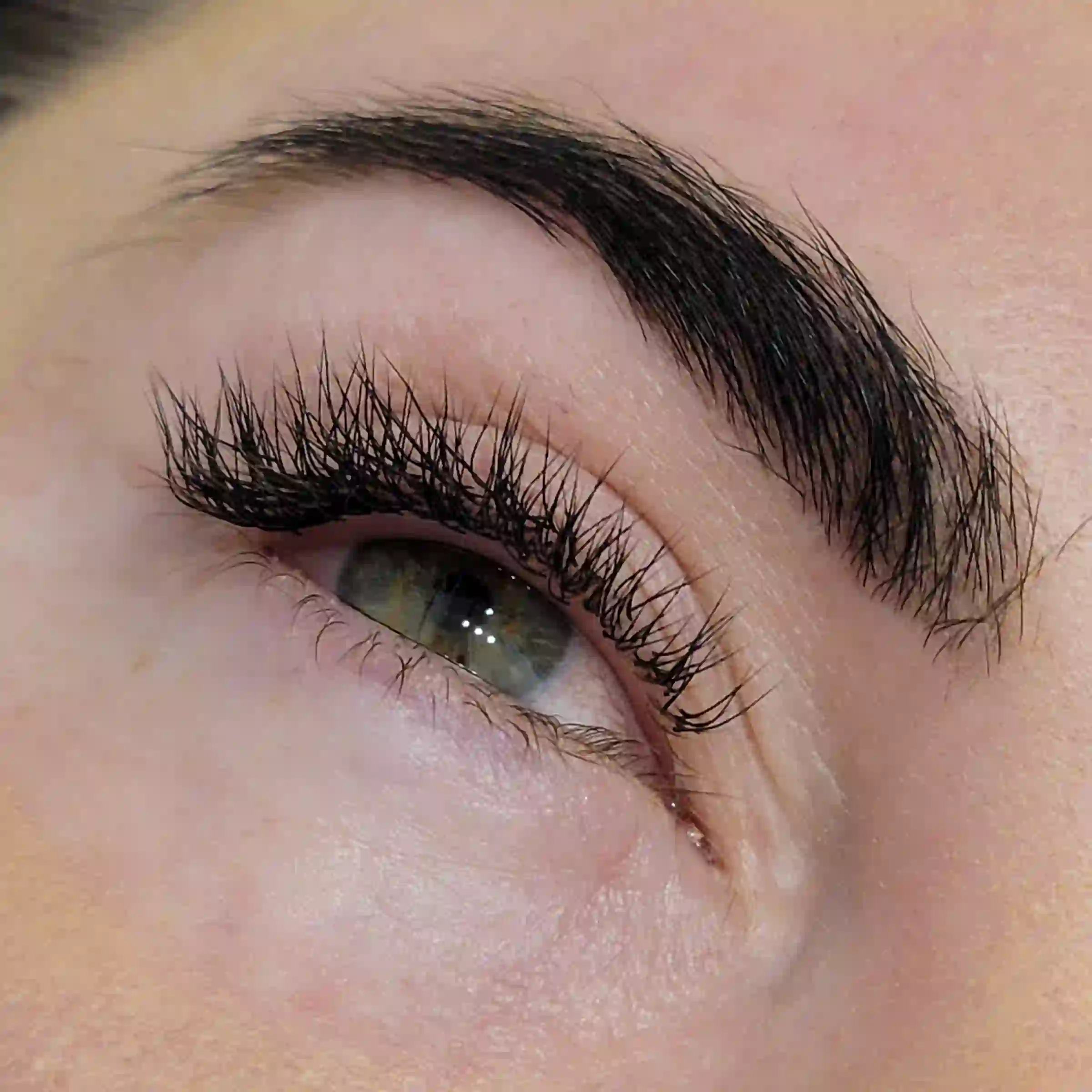 Angled close up of volume lash extensions with feathered tips and natural curl, mobile lash service by Opalya in Toronto