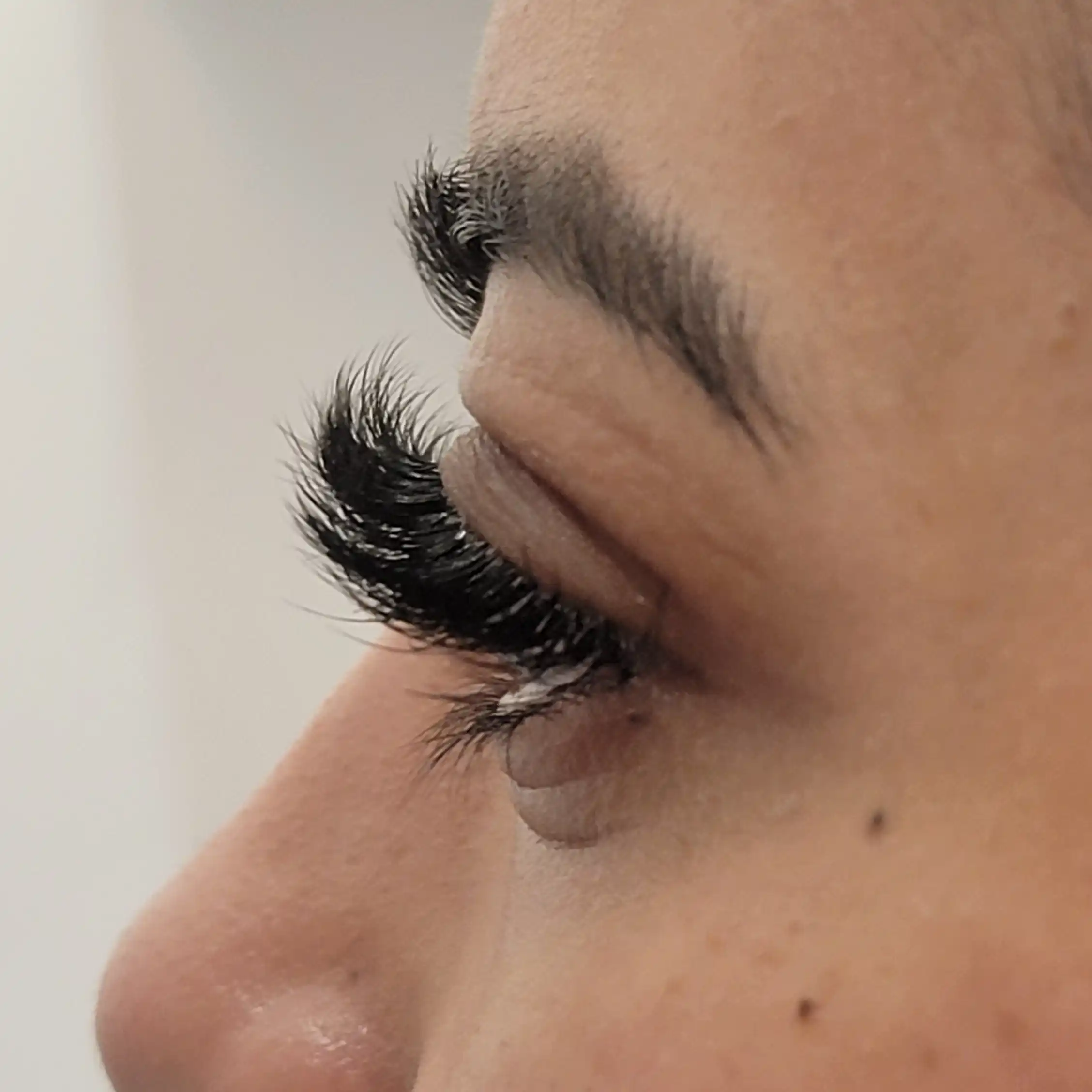 Close up of eye with fluffy volume lash extensions and defined outer corner, luxury lash treatment by Opalya