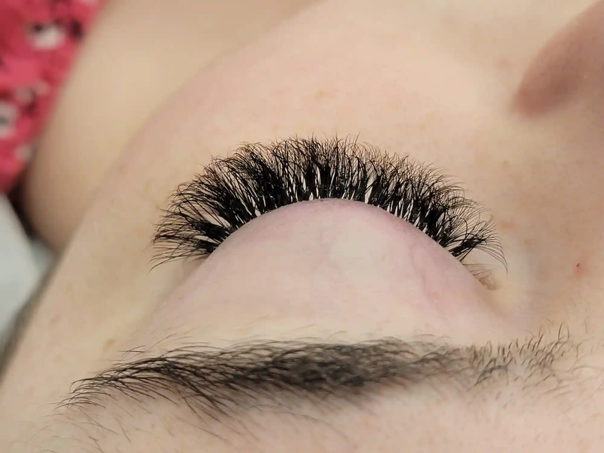 Upward angled close up of volume lash extensions with bold curl and full lash coverage