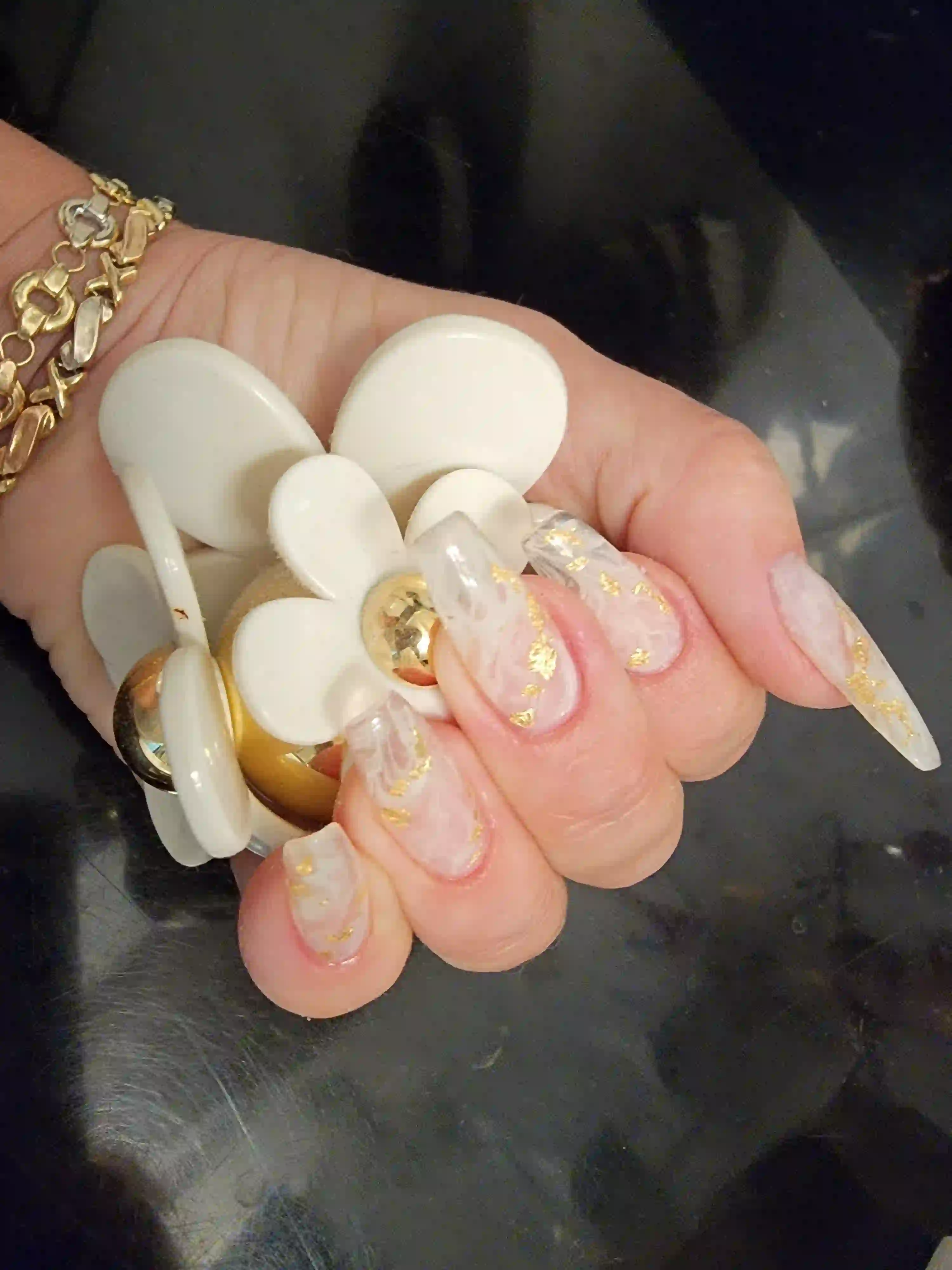 Sheer pink coffin nails with gold foil accents and glossy finish, luxury gel manicure by Opalya mobile spa in Toronto