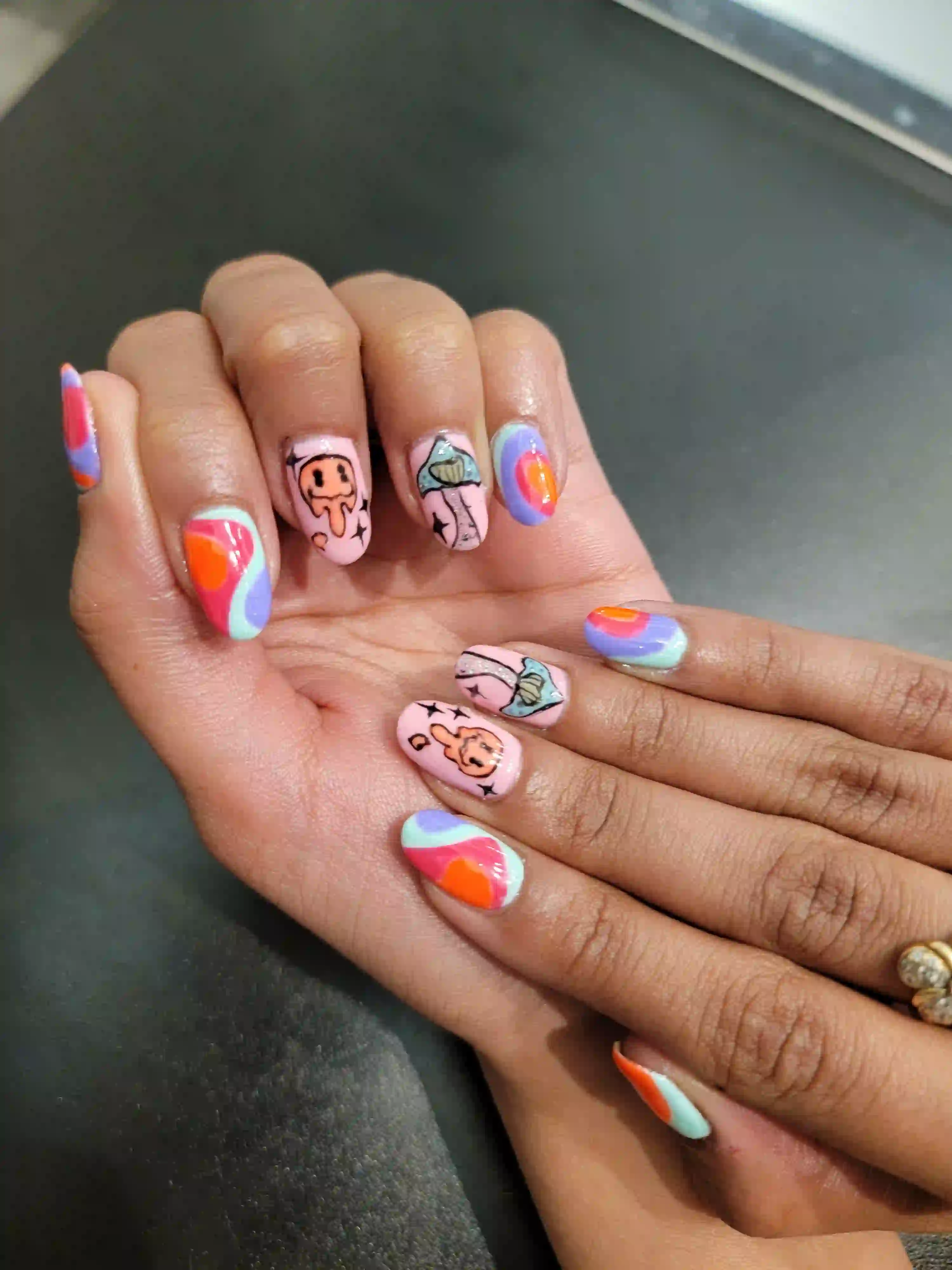 Colorful abstract nail art manicure with pastel swirls and hand painted designs on short almond nails, creative gel nails by Opalya mobile spa