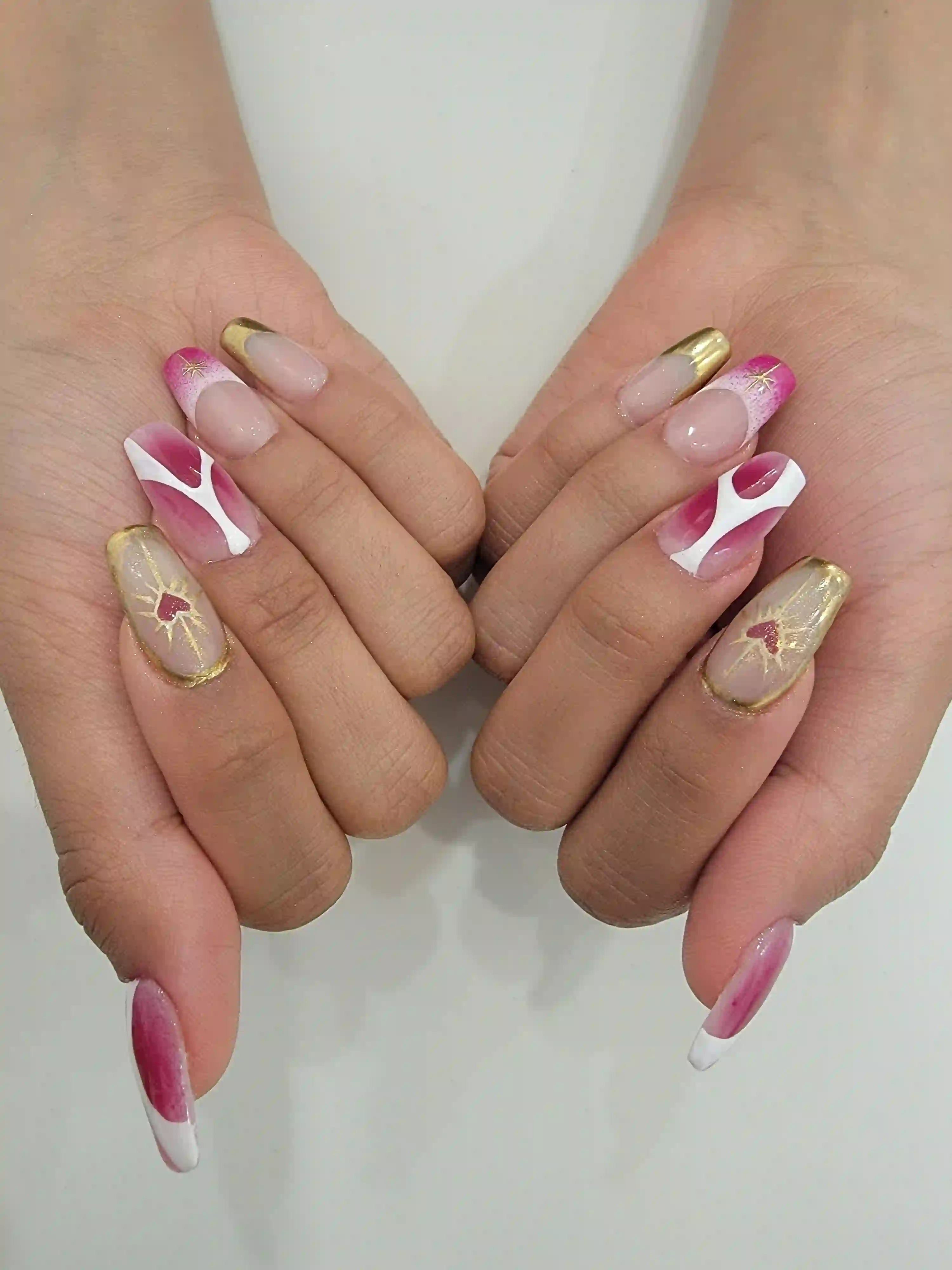 Pink and gold abstract nail art with French tips and fine line detailing on almond nails, luxury gel manicure by Opalya