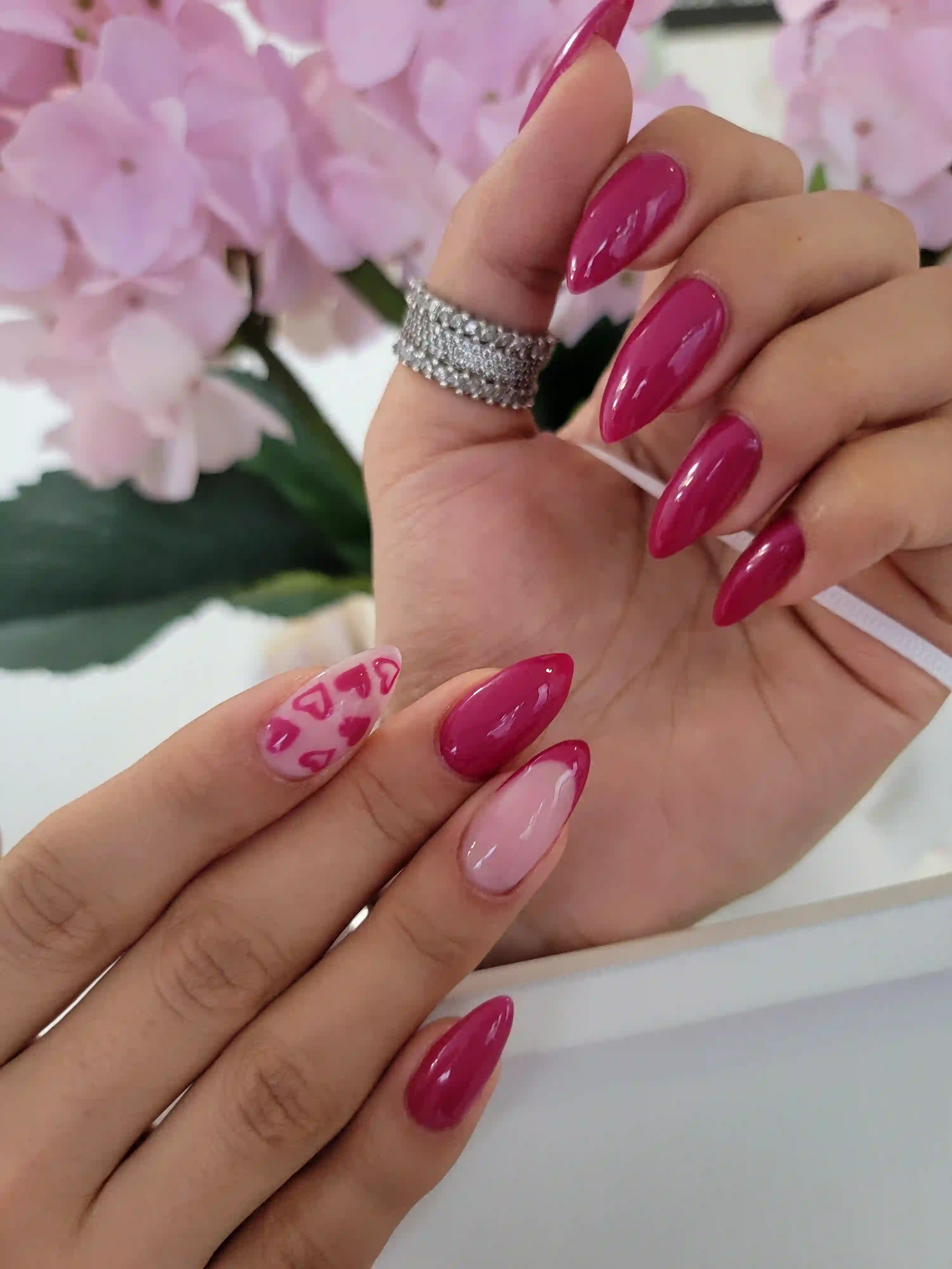 Glossy magenta almond nails with pink heart accent nail, bold romantic gel manicure by Opalya mobile nail service