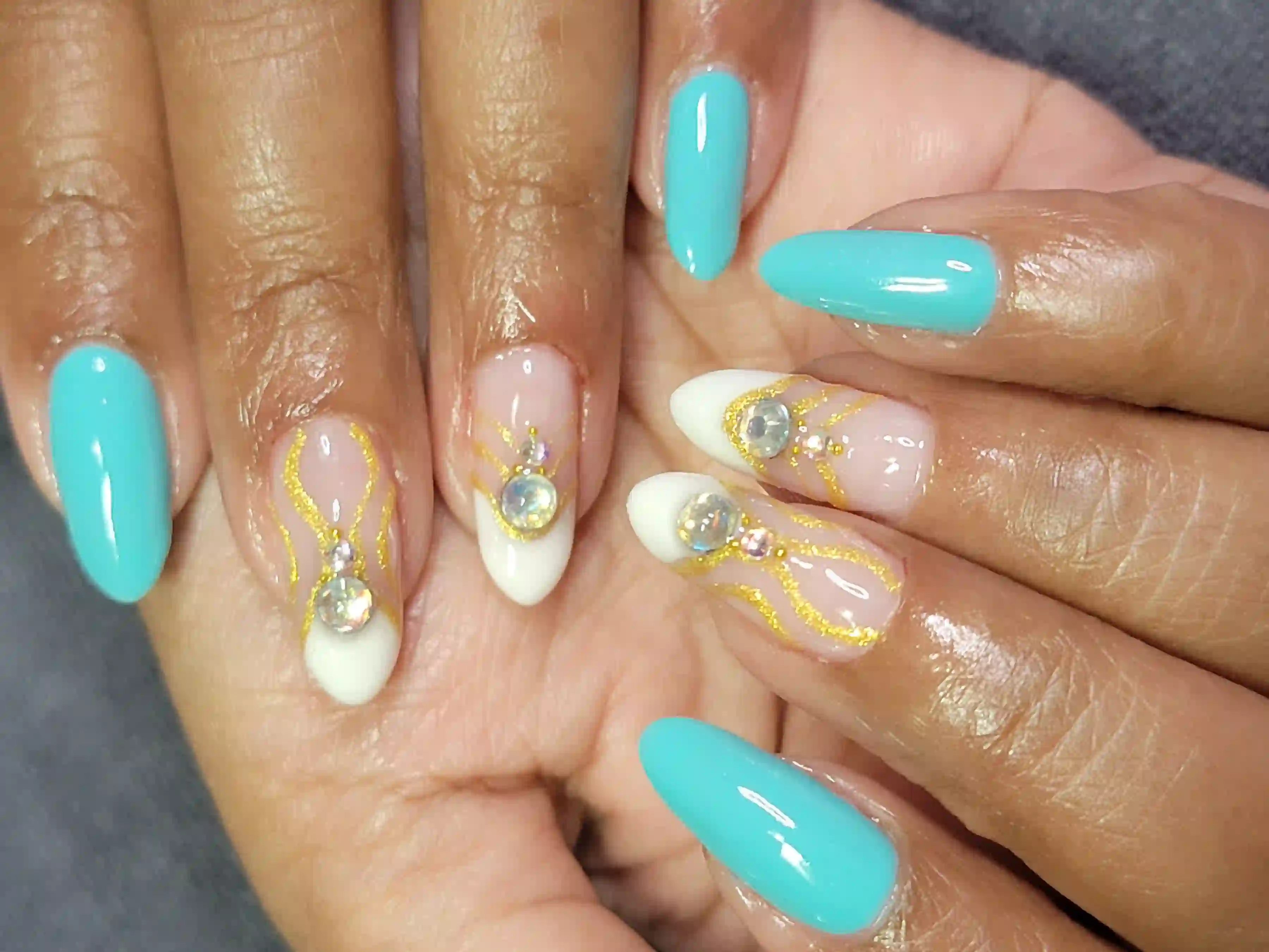Turquoise and white almond nails with gold detailing and crystal accents, luxury gel manicure by Opalya mobile spa