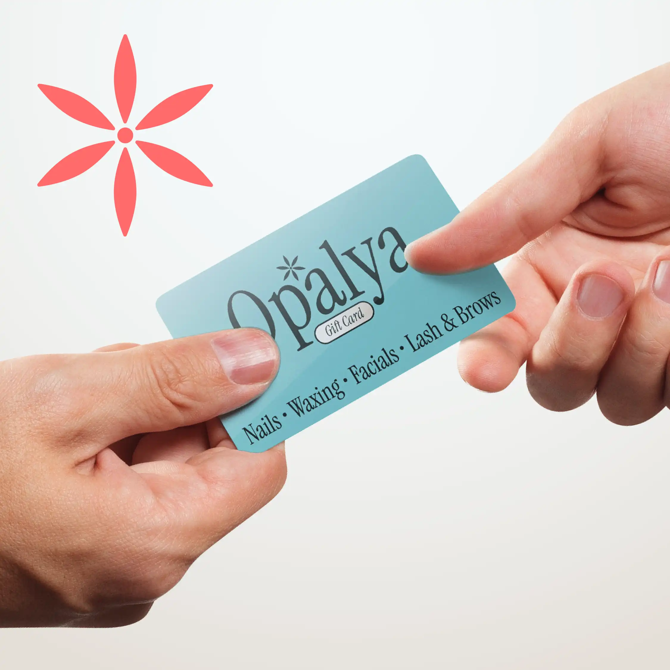 Two hands exchanging a teal Opalya gift card that reads “Nails • Waxing • Facials • Lash & Brows,” with a coral flower logo on a light background.