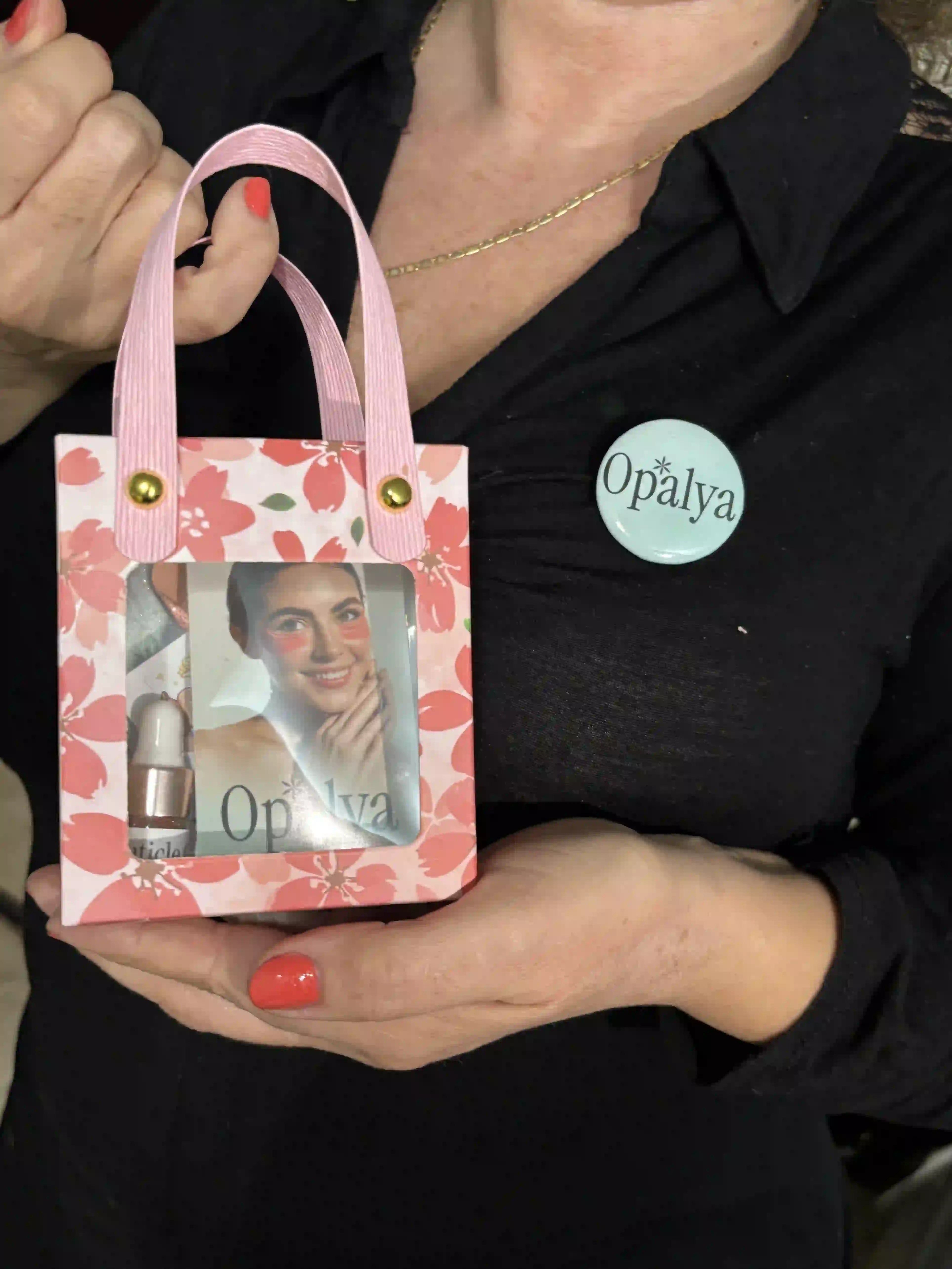 Opalya spa birthday goody bag with cuticle oil, mini manicure set, and under-eye patches in floral packaging.