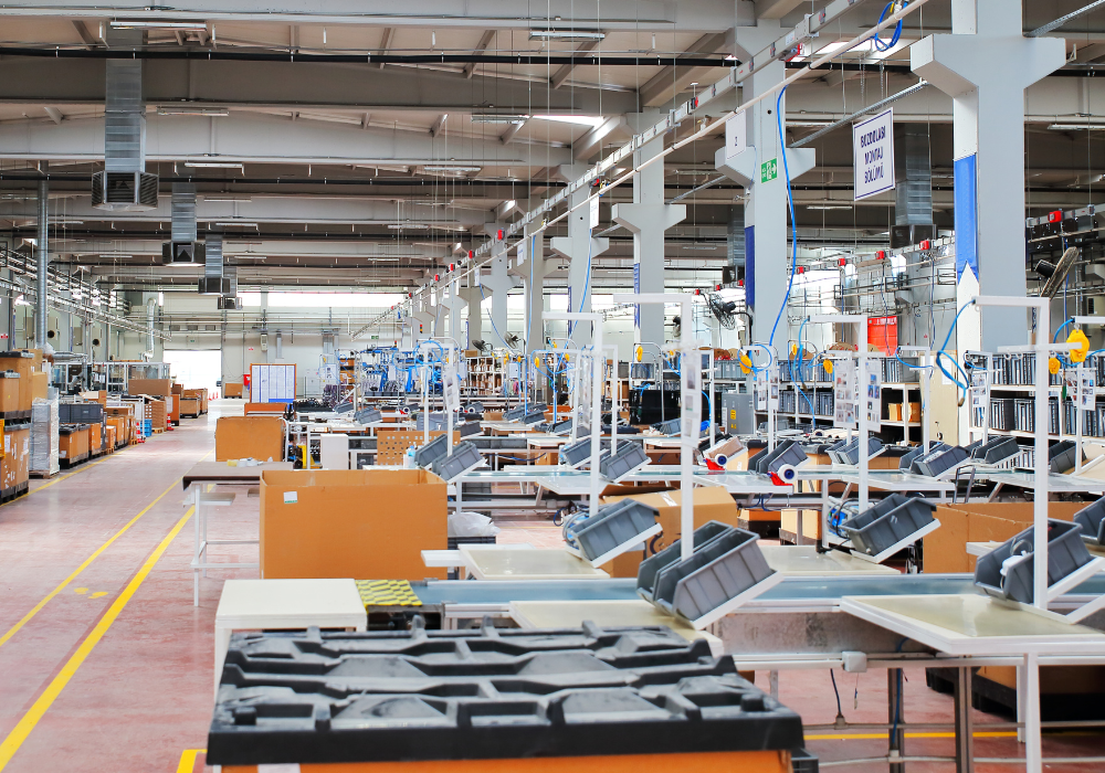 Interior view of a large, organized manufacturing facility with assembly lines and equipment.