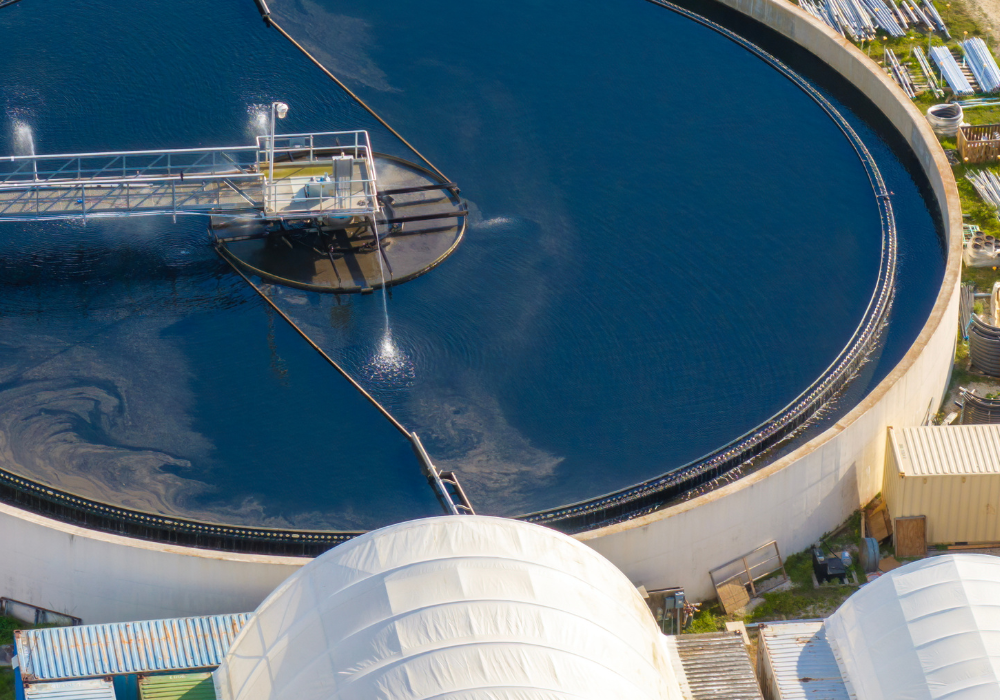 Aerial view of a circular water treatment tank with aeration system in an industrial facility.