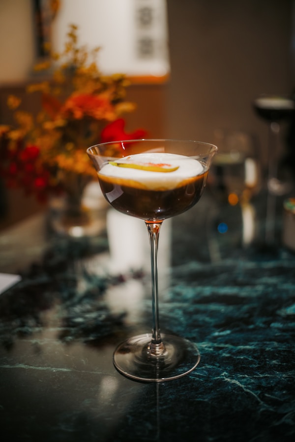 Espresso martini with foam and garnish on table