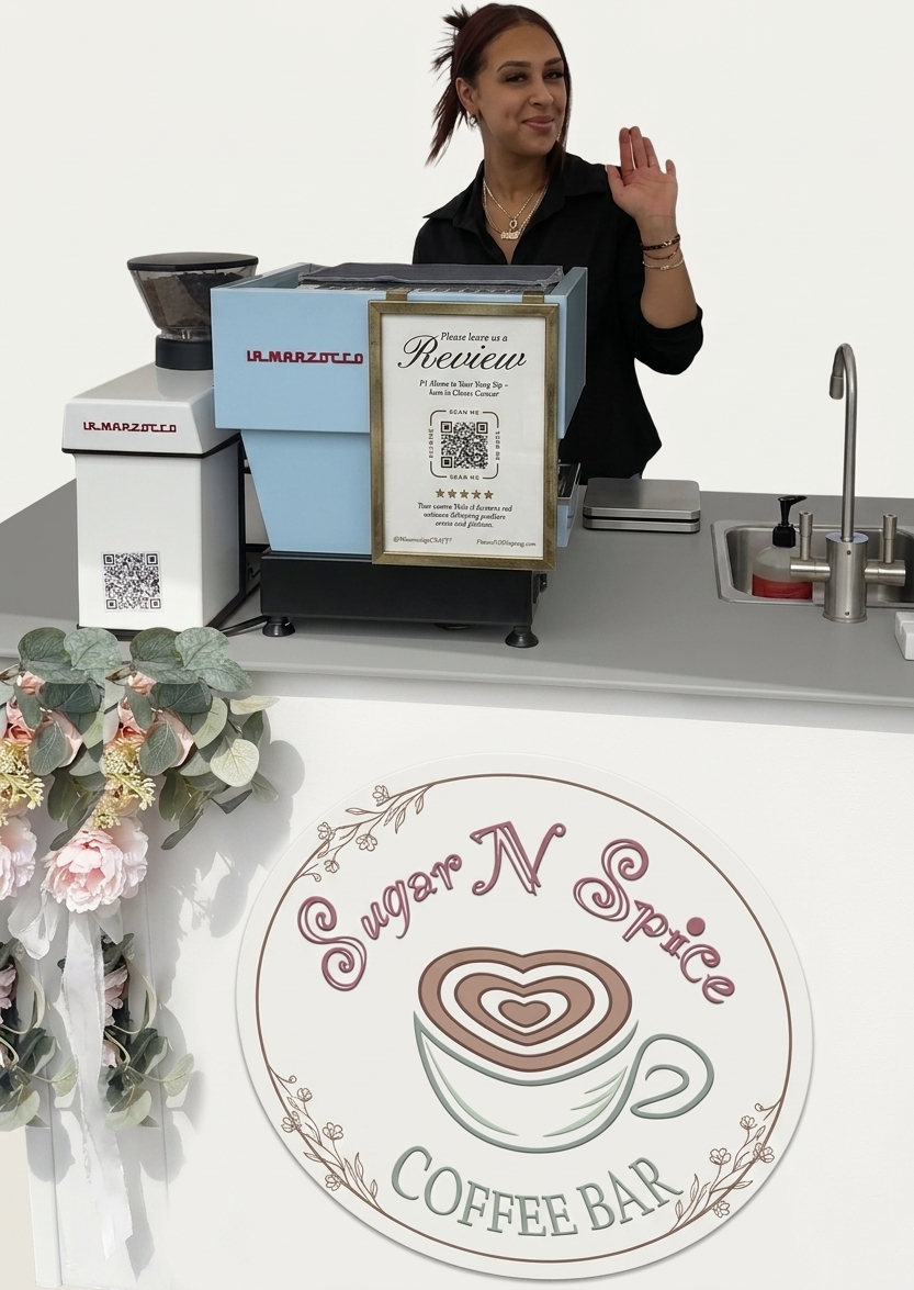 Barista waving behind a counter with a coffee machine and Sugar N Spice Coffee Bar sign with flowers.