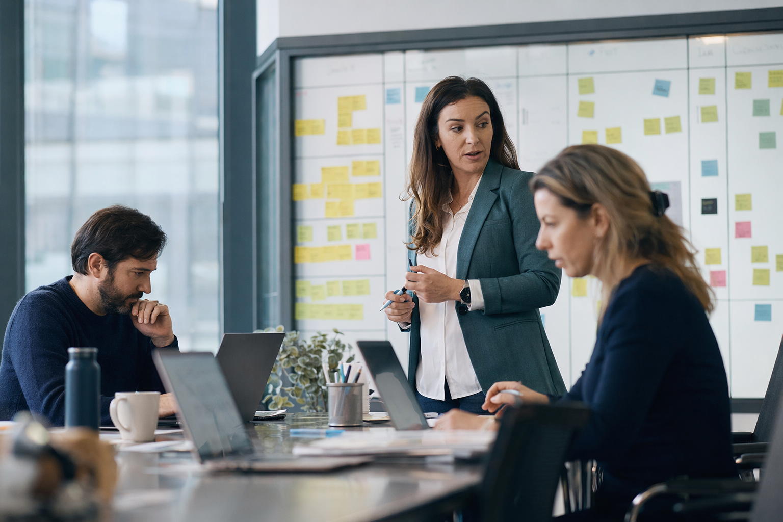 Équipe de projet coordonnant le déploiement graduel d'un système ERP devant un tableau kanban dans un bureau québécois