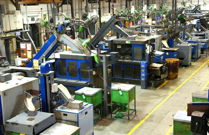 Industrial manufacturing floor with production equipment and marked working lanes.