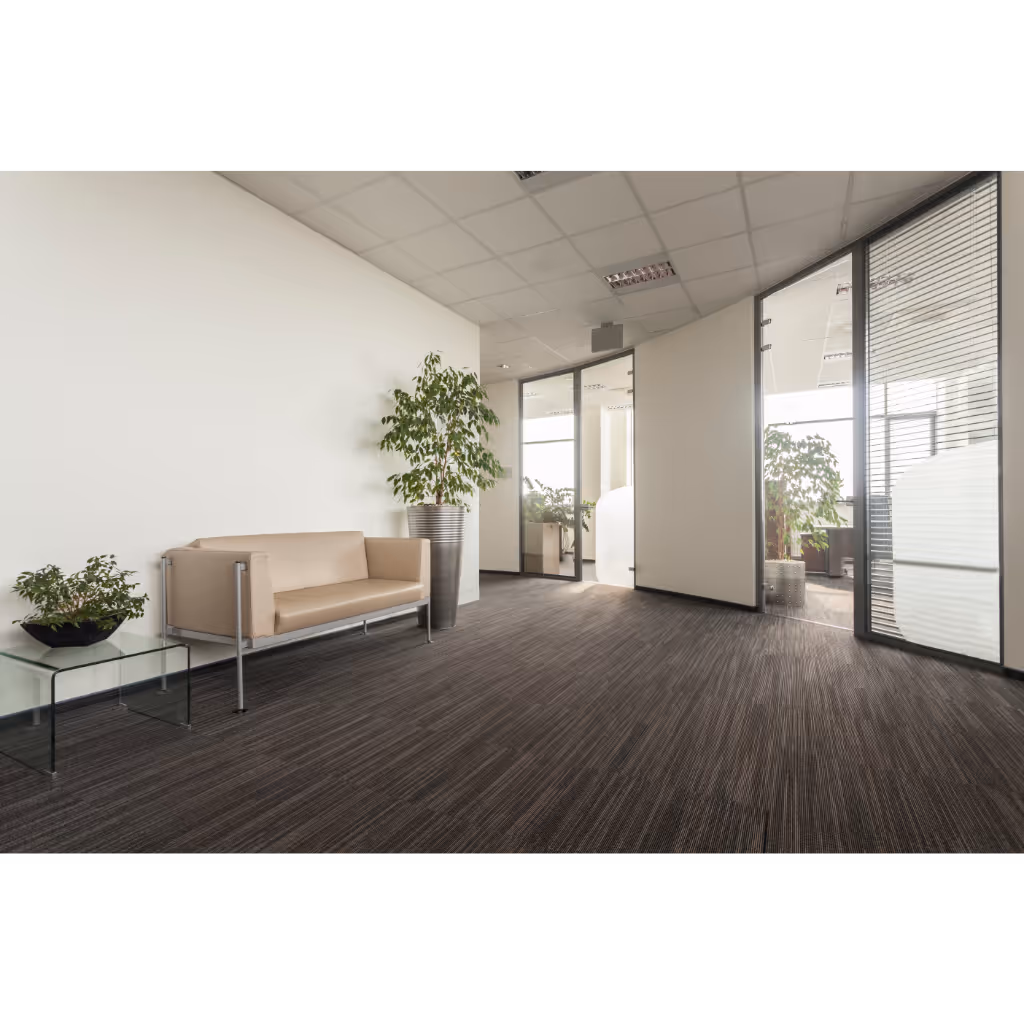Person cleaning a brown carpeted staircase using a professional carpet cleaning tool with steam.