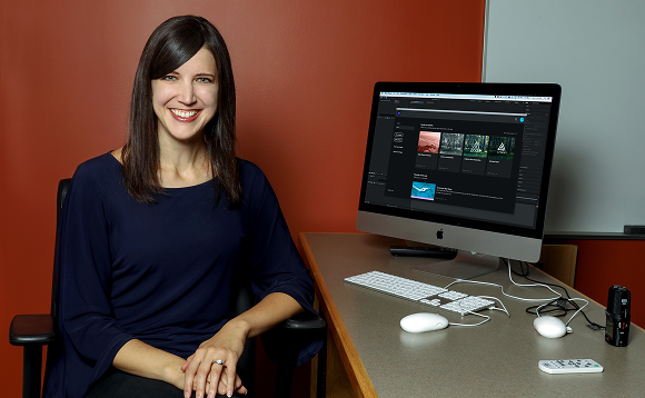 Photograph of Associate Professor Amanda Quist sitting in front of computer