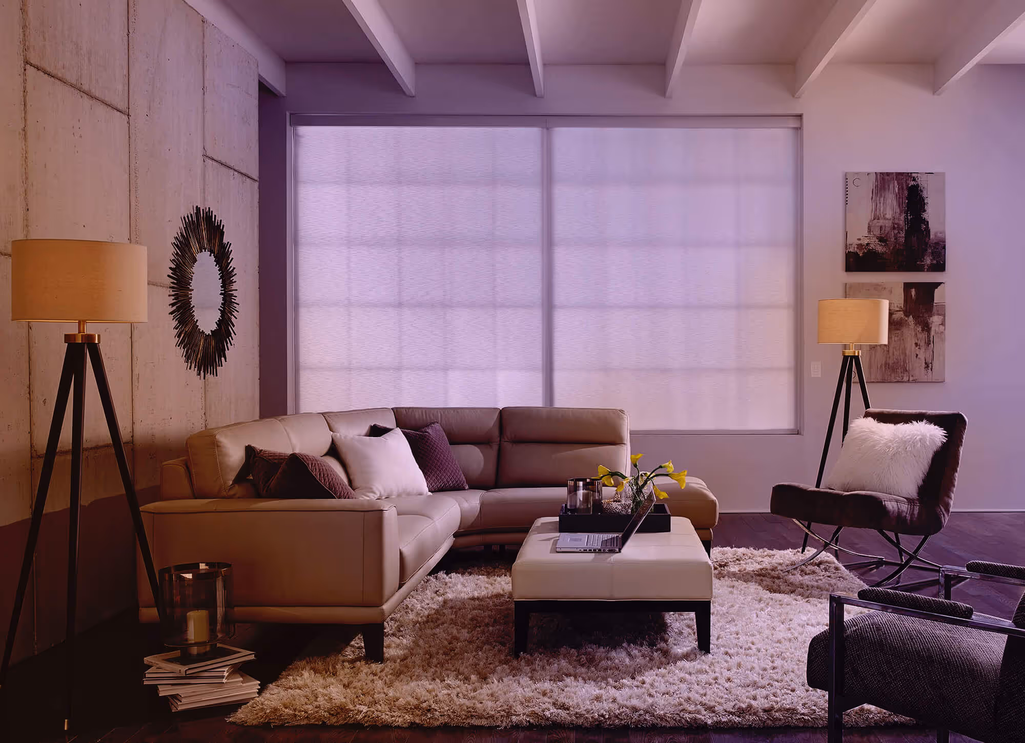 Modern living room with sectional sofa and large window shade.