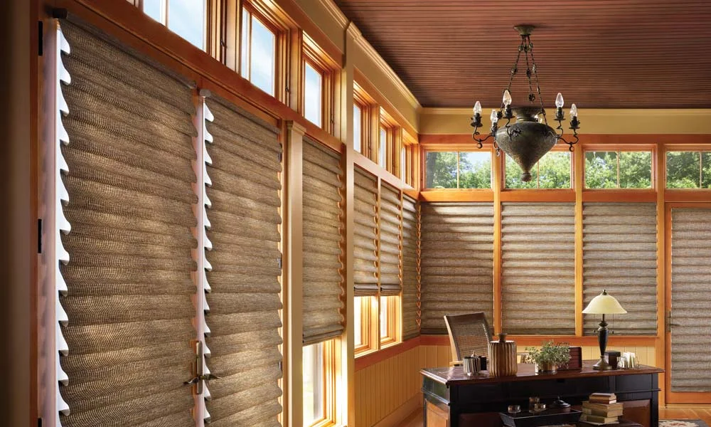 Sunroom with woven window shades and wood trim.
