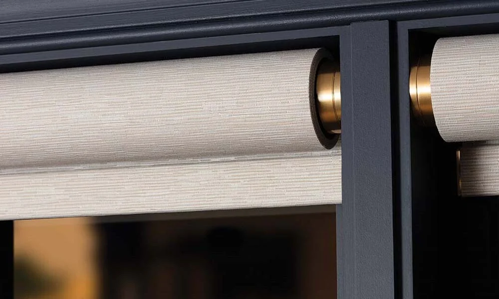 Close-up of roller shade in window frame.
