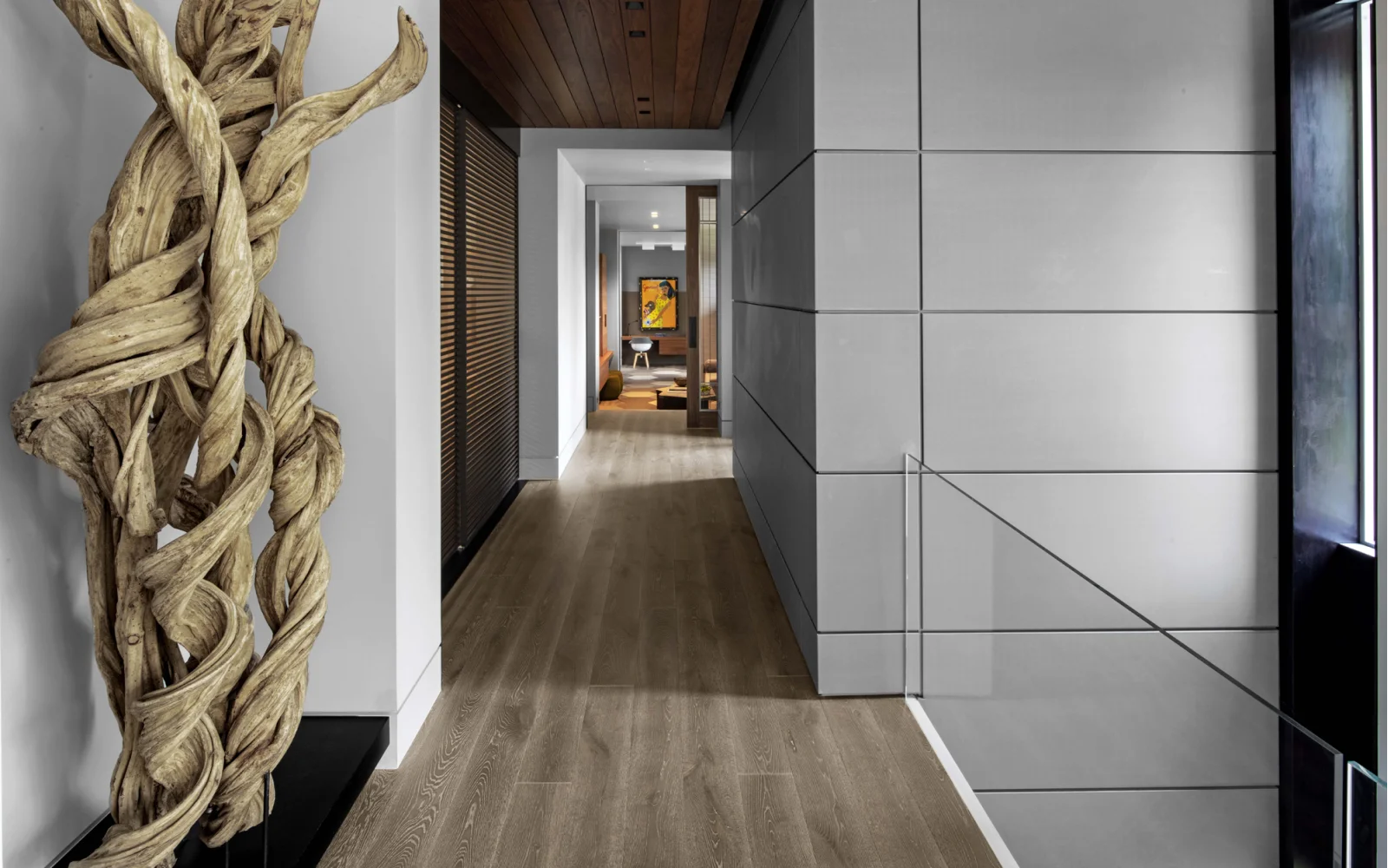 Modern hallway with wood floors and wall art.
