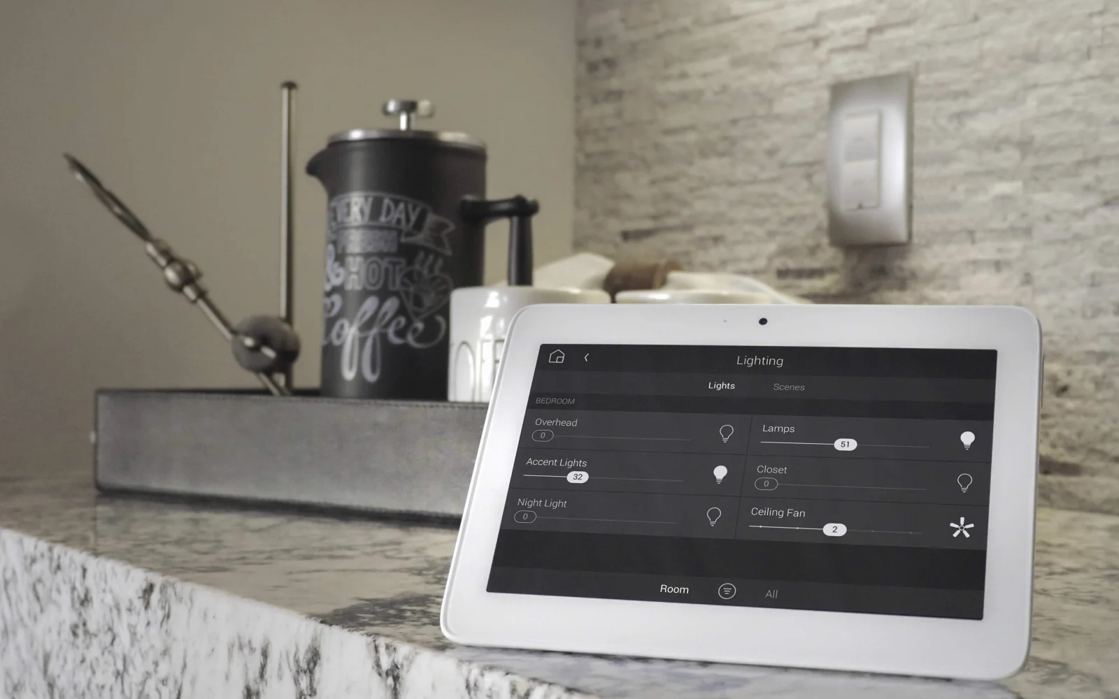 Smart home tablet controlling lighting on kitchen counter.