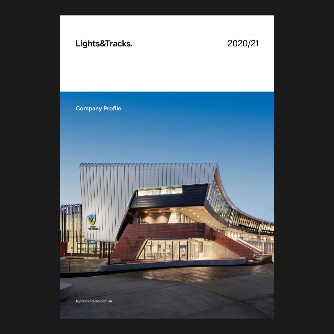 Booklet cover design snapshot featuring modern architectural building with curved metal and glass facade illuminated at dusk.