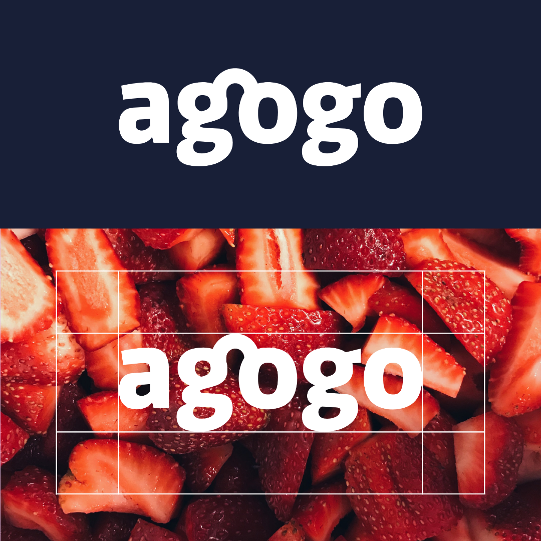 The word 'agogo' in bold white text on a dark blue background and overlaid on a close-up photo of sliced strawberries.