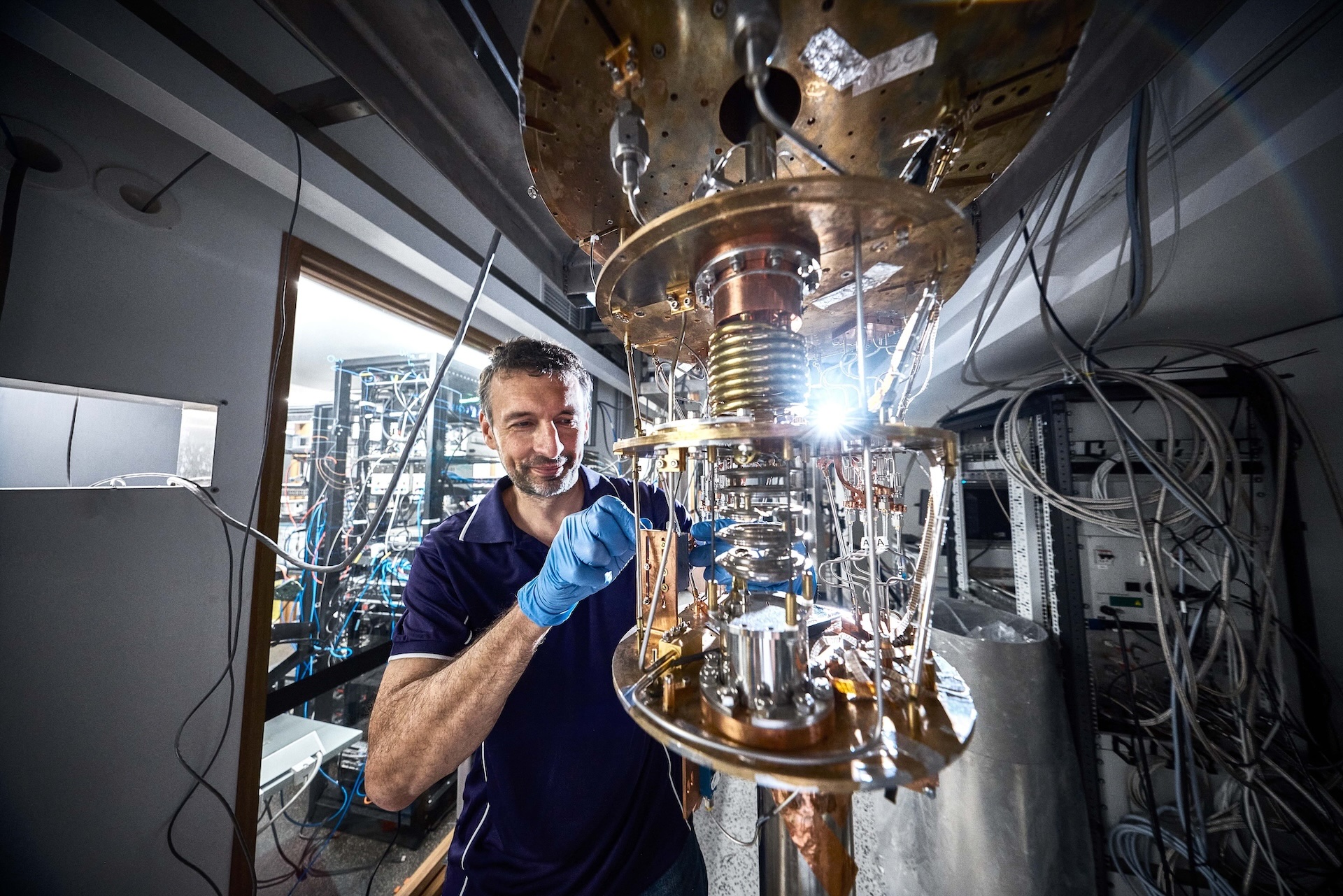 A technical specialist working on a piece of technology inside the University of Queensland's Centre for Quantum Computation and Communication Technology.