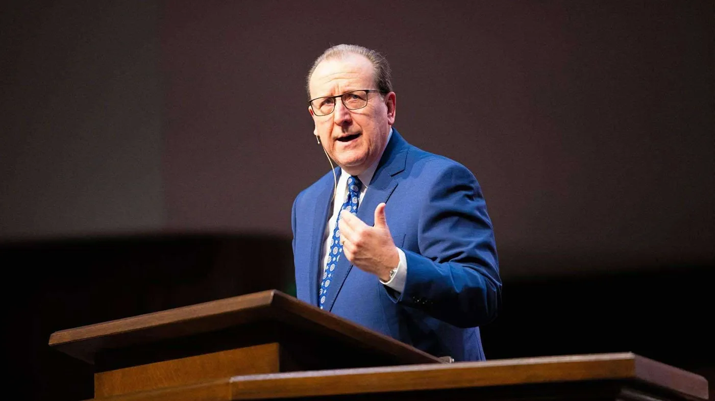 A man giving a speech at a podium.