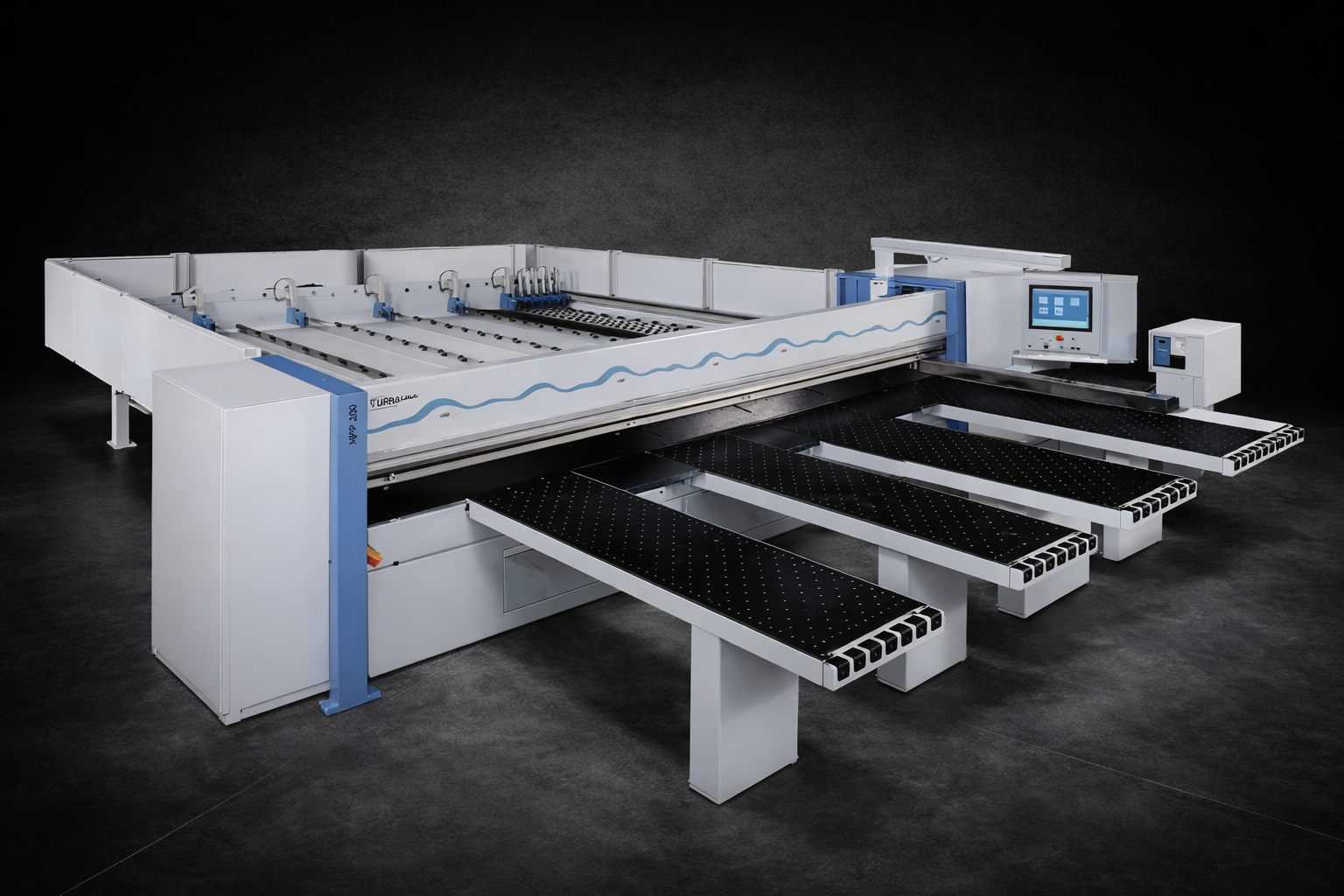 Person operating a stainless steel industrial control panel with numerous labeled buttons, switches, and digital displays.