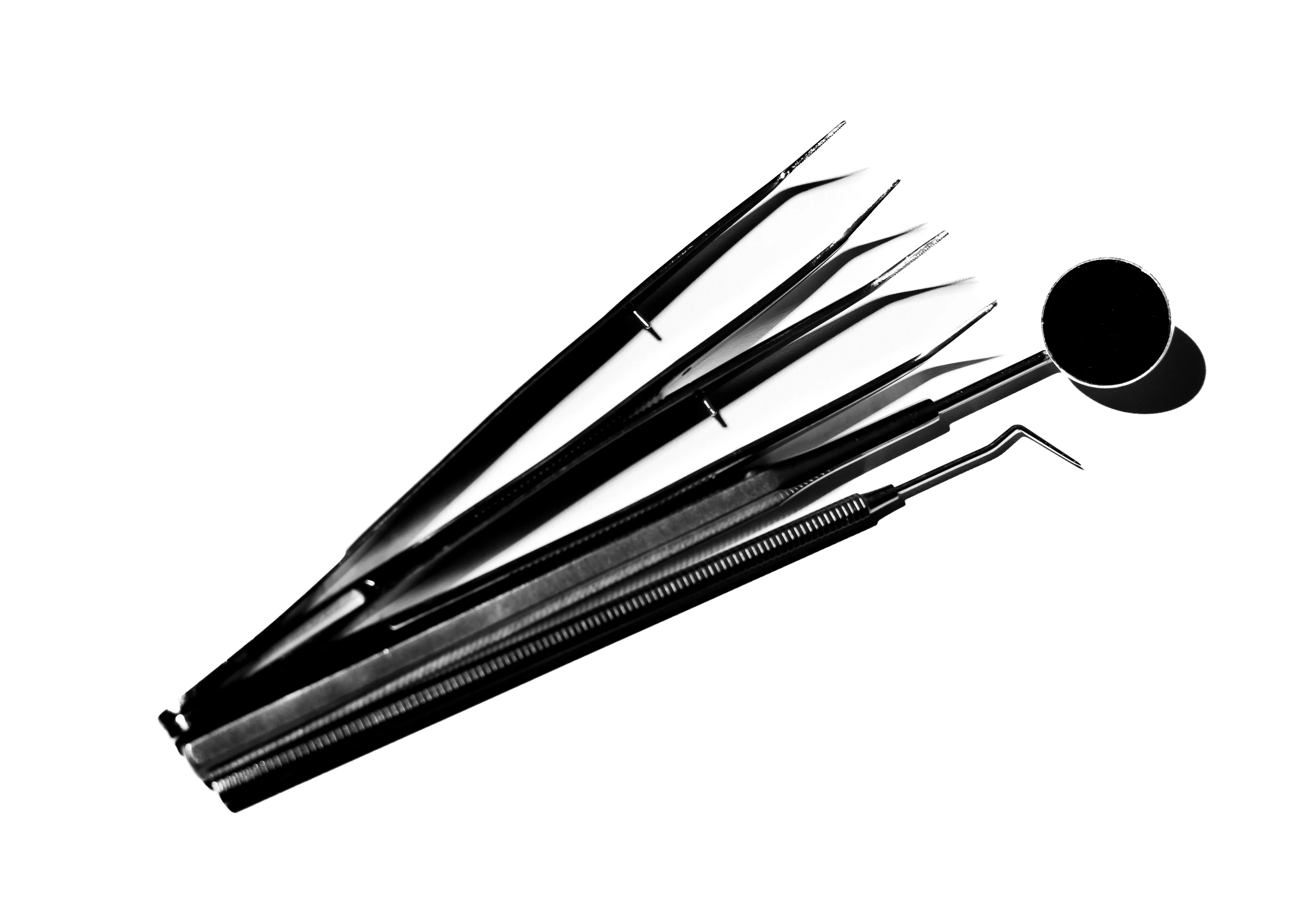 Set of dental tools including tweezers, a dental mirror, and a dental probe on a white background.