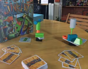 The board game Junk Art on a table with cards and colourful playing pieces