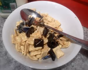 a bowl of cereal with Dungeons and Dragons minis scattered on it
