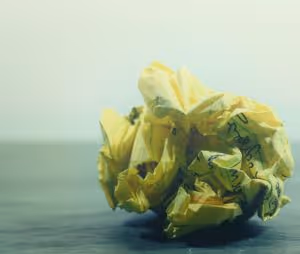 ball of paper with writing on it
