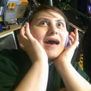 Woman looking scared with her hands on her cheeks in Lockhouse Escape Games foyer