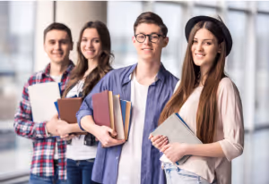 a group of students holding books and folders smiling at the camera