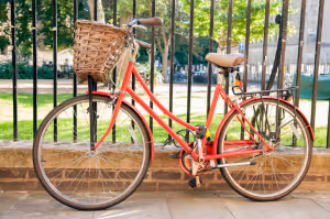 a bicycle chained to a railing outdoors in cambridge