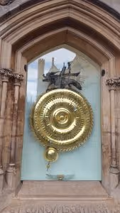 The Corpus Christi Clock, a large metal cricket on a large golden circular clock