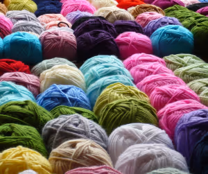 a collection of coloured balls of wool in a row