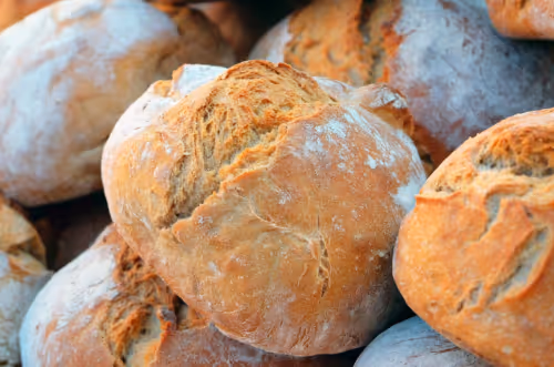 many stacked round loaves of bread