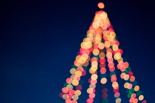 christmas lights forming a red green and gold pyramid on a blue background