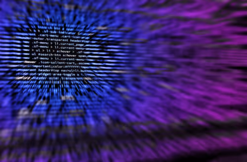 A black screen with blue and purple code numbers blurred on it