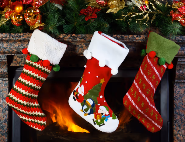 three christmas stockings in red and green in front of a fireplace