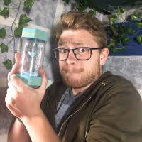 Man holding a timer which is almost out of time in LockHouse Escape Games