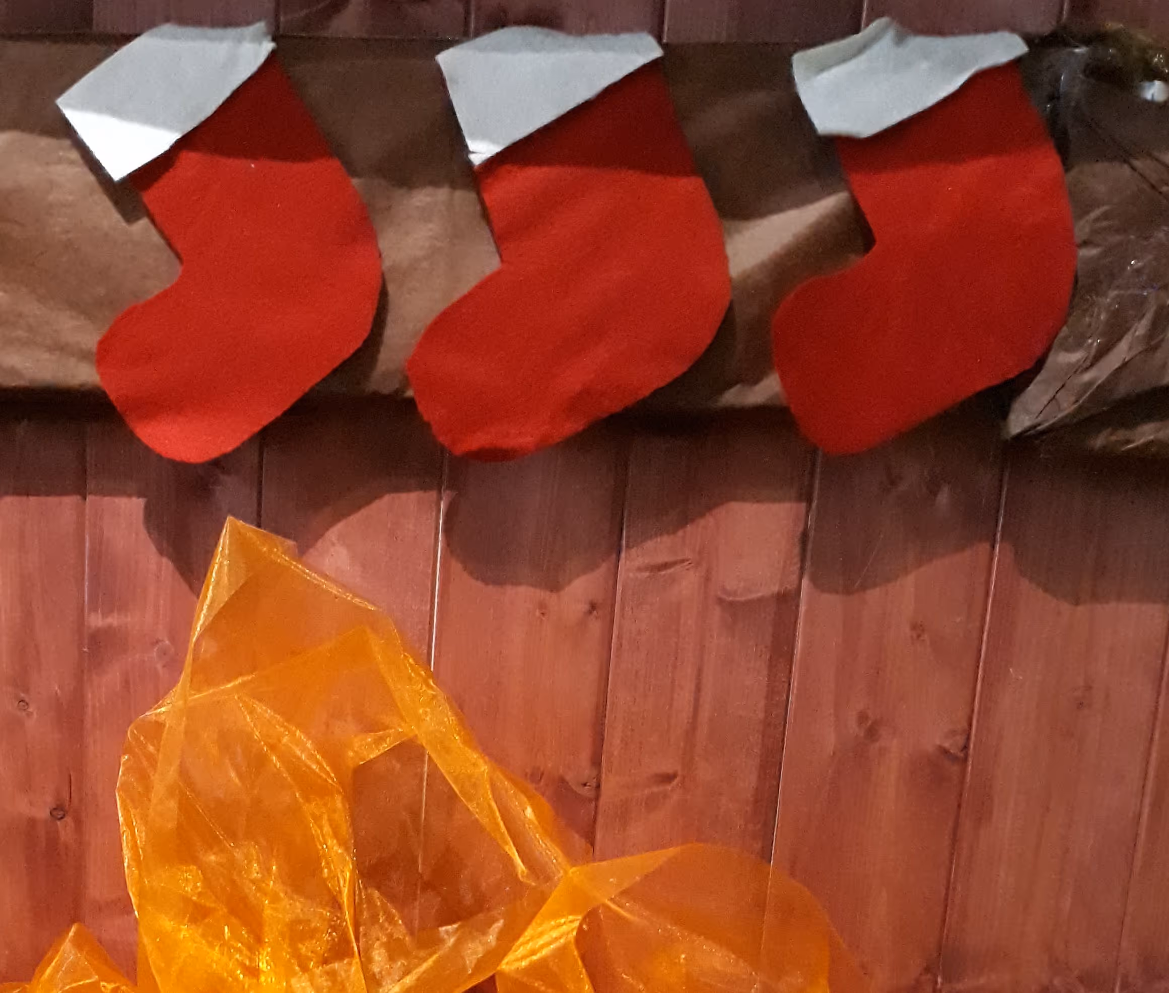 red and white stockings hanging above a fake fire