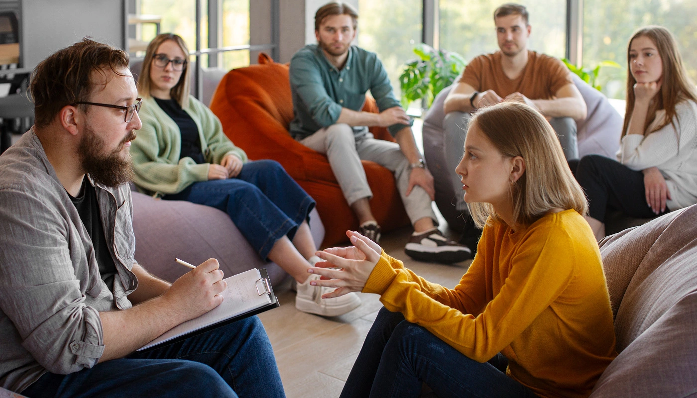 a group of people sitting in a circle
