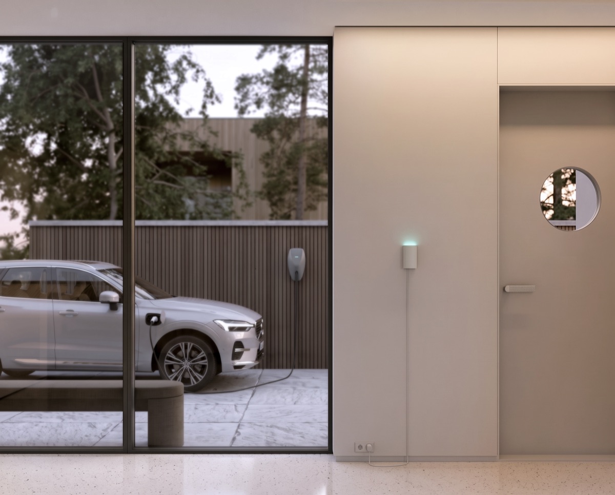Alva Link on an interior wall with an electric car charging outside