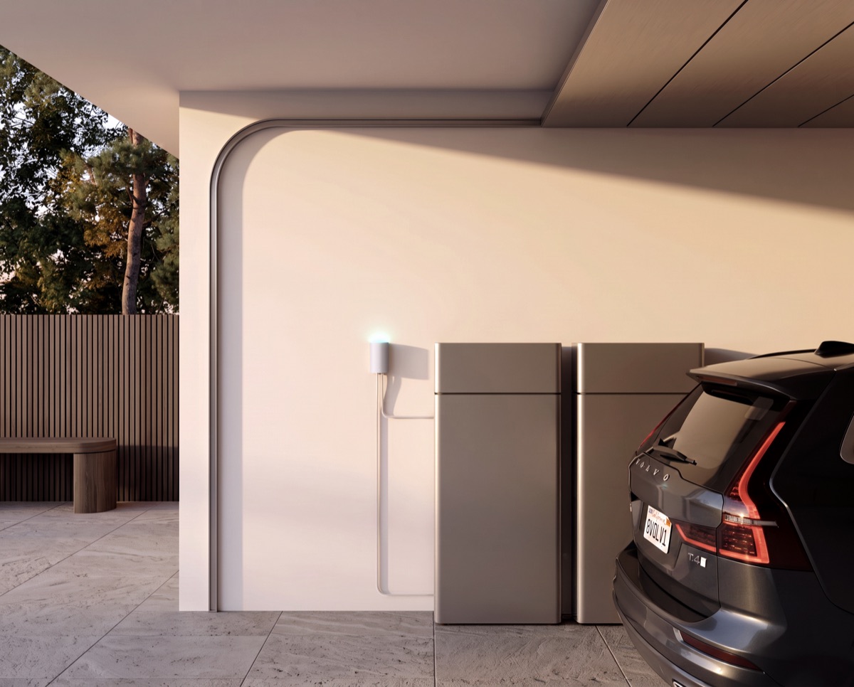 Alva Link next to a home battery in a carport