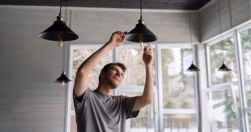 A man changing a light bulb