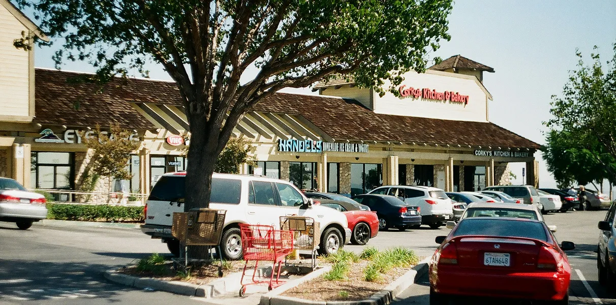 Parking lot in front of a suburban shopping plaza